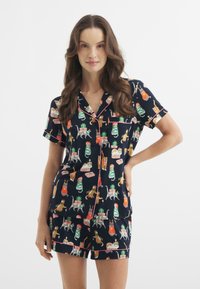 Niebieski zestaw piżamowy z krótkim rękawem i szortami, ozdobiony kolorowymi nadrukami zwierząt i wzorami prezentów, wykończony jasnoróżowym kolorem.