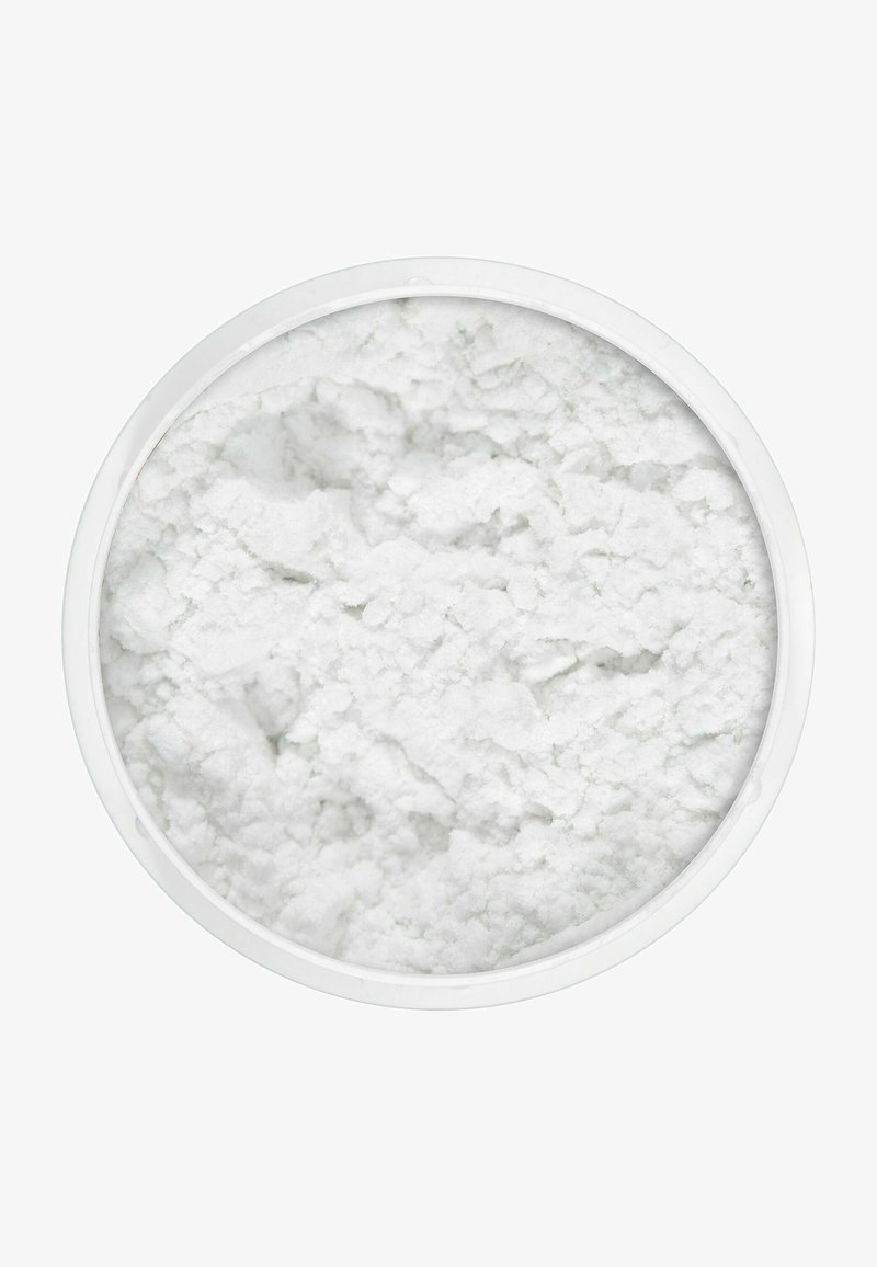 White powder in a round white plastic container, featuring a textured, granular surface with a soft, fluffy appearance.