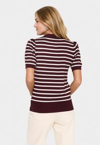 Maroon and cream striped knitted sweater with short sleeves, ribbed cuffs and hem, featuring a fitted design and smooth texture.