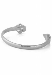 Silver cuff bracelet with a smooth, polished surface, featuring two rounded ends with cutout designs resembling animal paws.