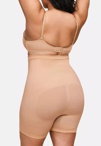 Hautfarbene nahtlose Miederware mit hoher Taille, verstellbaren Trägern und einem glatten, dehnbaren Stoff, der den Körper konturiert.