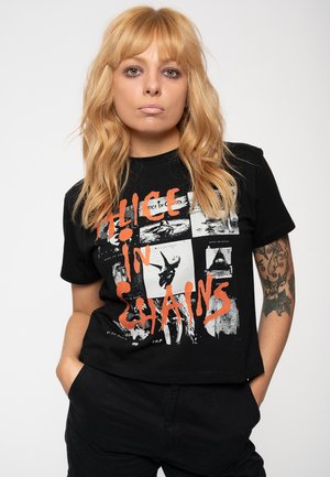 Black cotton t-shirt featuring a graphic design with orange text "Alice in Chains" and various monochrome images. Short sleeves, relaxed fit.