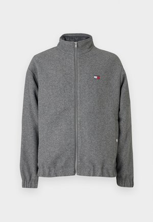 Hallukka hallhalli tõmblukk-jakk pehmest kangast, millel on kõrge krae, elastsed varrukad ja rinnal väike logo paik.