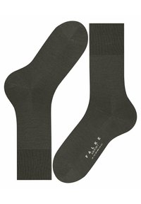 Calcetines de color verde oscuro con una textura suave. Presentan un puño superior acanalado y un branding mínimo en la suela. Forma y diseño clásicos.