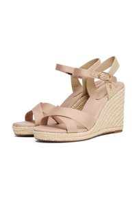 Nude leather wedge sandals with crisscross straps, jute-wrapped soles, and an adjustable ankle strap. Gold hardware detail included.