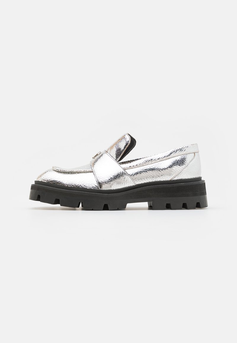 Metallic silver loafers with a rounded toe and a black chunky sole. Features a flat strap across the vamp and textured upper surface.