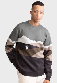 Knit sweater featuring a mountain landscape pattern in gray, tan, and dark colors, round neckline, and ribbed cuffs and hem.