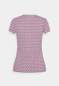 Short-sleeve, fitted t-shirt featuring a geometric pattern in red, navy, and white. Material appears smooth with a round neckline.