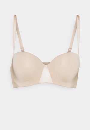 Beige padded bra with smooth fabric, featuring a triangular center detail. Adjustable straps and a subtle sheen finish.