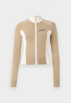Knit zip-up sweater in beige and cream with long sleeves, ribbed cuffs, and contrasting panels. Features a logo on the left chest.