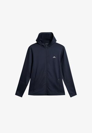 Kapuze-Jacke in Marineblau, aus glattem, geschmeidigem Stoff. Mit durchgehendem Reißverschluss auf der Vorderseite und zwei seitlichen Taschen. Dezentes Logo auf der Brust.