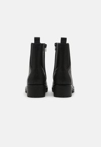 Black leather ankle boots with textured finish, rounded toe, and chunky rubber sole. Features side zip closures and pull-tabs.