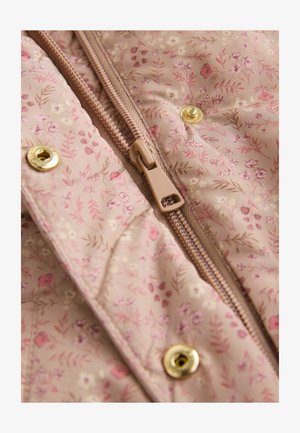 Padded jacket featuring a light pink fabric with floral patterns, a central zipper in a tan hue, and gold snap buttons for closure.