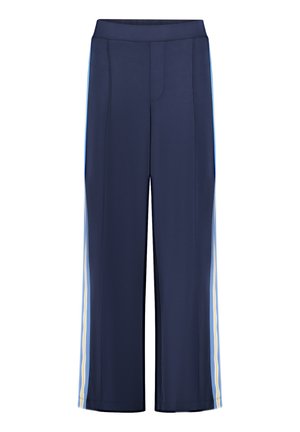 Pantalon large marine avec une texture lisse, présentant des rayures verticales bleu clair et jaune sur les côtés. Taille élastique.