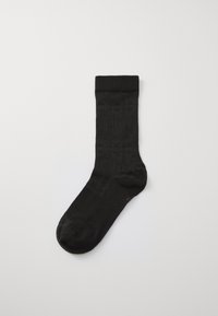 Sosete negre de echipă cu un model texturat și o culoare solidă. Manșetă ribbed în partea de sus pentru o potrivire perfectă. Finisaj neted pe toată suprafața.