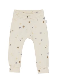 Cremefarbene Babypants mit umgeschlagenen Bündchen, die ein Muster aus kleinen beige, braunen und grauen Punkten zeigen, die überall verteilt sind.