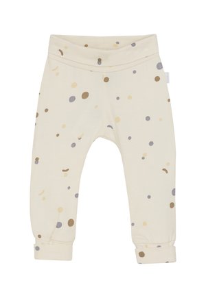 Cremefarbene Babypants mit umgeschlagenen Bündchen, die ein Muster aus kleinen beige, braunen und grauen Punkten zeigen, die überall verteilt sind.