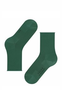 Chaussettes vertes en tissu respirant, avec une texture lisse, un poignet côtelé et des détails de logo sur la semelle.