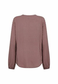 Red and navy patterned blouse with long sleeves, round neckline, and elasticized cuffs. Lightweight, textured fabric with an all-over geometric design.