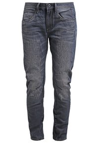 Tummat farkut, joissa on haalistuneita kohtia ja tekstuurilla ommeltu sauma. Varustettu viidellä taskulla, etupainikkeella ja slim fit -kaihin. 