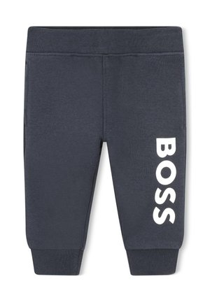Pantalons de jogging bleu foncé en tissu mélangé coton, avec des poches latérales et un grand logo "BOSS" blanc imprimé sur la jambe gauche.