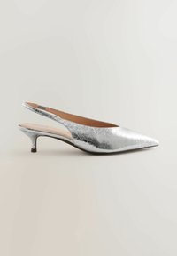 Sølv slingback-sko med spids tå, lavet af struktureret metallisk materiale. Har en lav hæl og et udskåret område ved anklen.