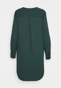 Dark green long-sleeve shirt dress with a straight cut, rounded hem, back pleat, and buttoned cuffs. Smooth fabric texture.