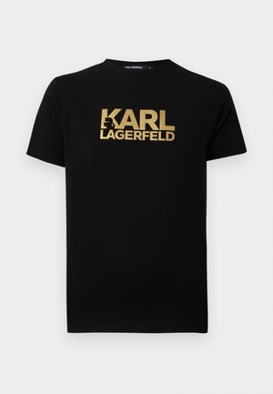 T-shirt nera in cotone con la scritta dorata "KARL LAGERFELD" sul davanti. Maniche corte e design classico a girocollo.