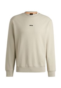 Beige sweatshirt i bomull med rund halsringning, långa ärmar, ribbade ärmslut och nederkant, med en liten svart "BOSS"-logotyp på bröstet.