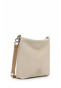 Beige leather handbag with a textured finish, silver hardware, and an adjustable strap. Compact, minimalist design with a subtle logo detail.