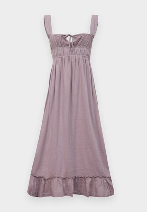 Liliowa sukienka bez rękawów z marszczonym dekoltem, regulowanym wiązaniem i falbaniastym wykończeniem. Wykonana z lekkiego materiału o gładkiej strukturze.
