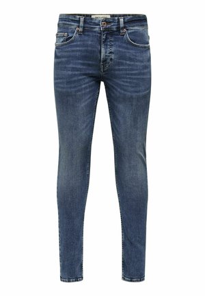 Kitsas tumedast sinisest denimpaarist, millel on pleekinud viimistlus, viis taskut ja metallist nööbiga sulgemine. Õmbluste ääres on õmblusaktsendid.