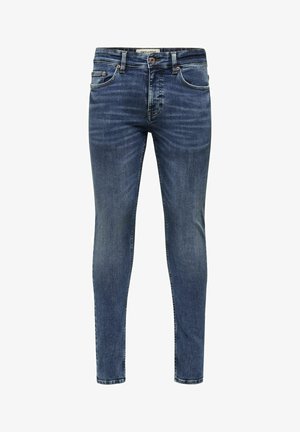 Kitsas tumedast sinisest denimpaarist, millel on pleekinud viimistlus, viis taskut ja metallist nööbiga sulgemine. Õmbluste ääres on õmblusaktsendid.