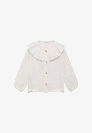 Valkoinen, teksturoitu nappipaita, jossa on suuri, ryhdikäs kaulus ja puffattuja pitkät hihat. Sisältää puunapit ja läpiviennit kauluksessa.