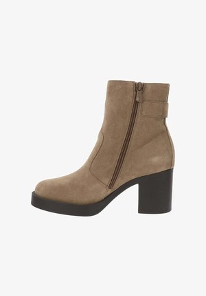 Bottines en suédine marron avec un bout arrondi, une fermeture éclair sur le côté, un épais talon noir et un détail de lanière à la cheville. Texture lisse, design moderne.