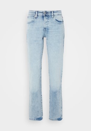 Jeans en denim bleu clair avec une coupe droite, cinq poches, un léger effet de délavé et une texture légèrement vieillie au niveau de l'ourlet.