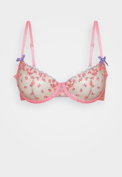 Korsett pitsitud nuditooniga, millel on roosad lillemustrid, lainelised servad ja reguleeritavad roosad rihmad, millel on väikesed lillakad sallid.