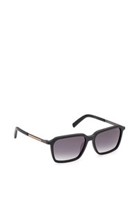 Lunettes de soleil rectangulaires noires avec des verres dégradés foncés et des branches fines ornées de subtils accents dorés.