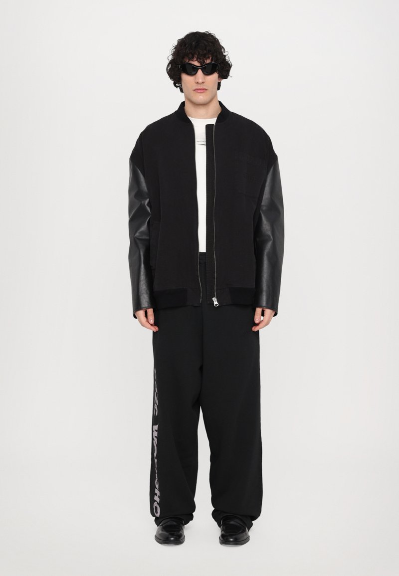 032c - OUTLAW OVERSIZED UNISEX - Tracksuit bottoms - faded black, Enlarge