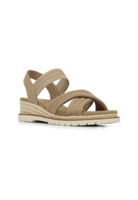 Sandalia beige con correas de tela cruzadas, suela intermedia de estilo alpargata tejida, suela de goma y acentos elásticos para un ajuste seguro.