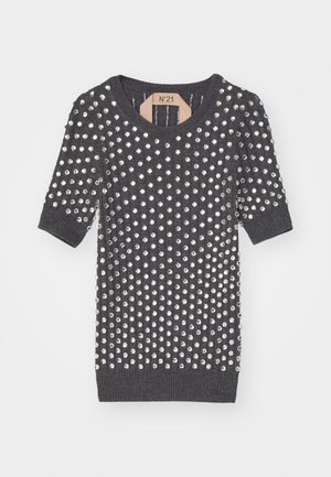 Siva pletena majica s kratkimi rokavi in okroglo izrezom, okrašena z mnogimi srebrnimi kovinskimi žebljički po površini.