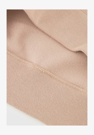 Light pink sweatshirt fabric showing a smooth interior layer and ribbed cuff details. Soft texture with consistent stitching around edges.