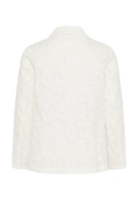 Witte geborduurde jas met lange mouwen, voorzien van een bloemenpatroon en uitsparingen, zachte textuur en een klassiek kraagontwerp.