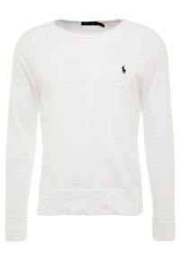 Vit sweatshirt med långa raglanärmar, rund hals och ribbade muddar. Har en liten marinblå logga på bröstet. Tillverkad av mjukt tyg.