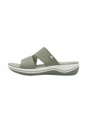 Sandalo slip-on in rete verde con due cinturini incrociati, tomaia testurizzata, soletta imbottita e suola intermedia bianca con suola in gomma per una migliore aderenza.