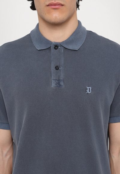 Polo shirt blu scuro realizzato in tessuto testurizzato, con abbottonatura a due bottoni, colletto a contrasto e piccolo logo ricamato sul petto.