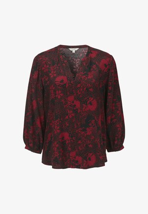Svart blus med en djup V-ringning, med ett rött blommönster, långa puffärmar och en lös passform. Strukturerad tyg med prickig bakgrund.