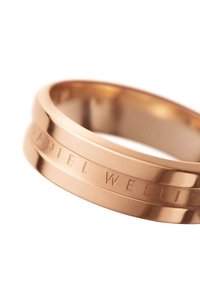 Ruusu kultainen sormus, jossa on teksturoitu rengas ja kaiverrettu "DANIEL WELLINGTON" -yksityiskohta; tyylikäs, pyöreä muoto, jossa on kaksi rinnakkaista uraa.