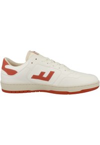 White leather sneaker with red accents, featuring a prominent logo, round toe, flat sole, and contrasting light tan midsole.