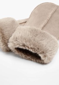 Beige faux fur mittens with a soft, fluffy cuff. Features a smooth exterior and stitched detailing for durability. Cozy and warm design.